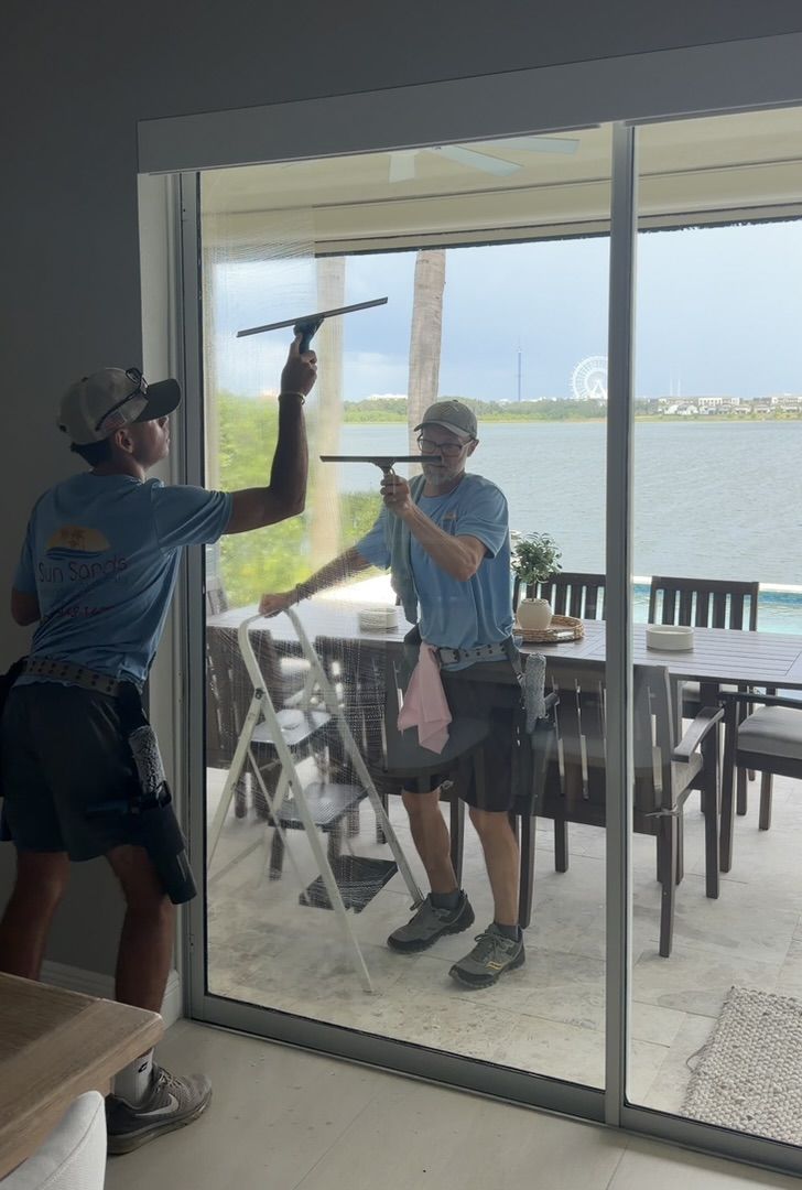 Sun Sands technician cleaning a window in Windermere, FL
