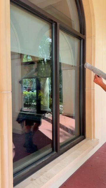 Sun Sands technician cleaning a window in Windermere, FL