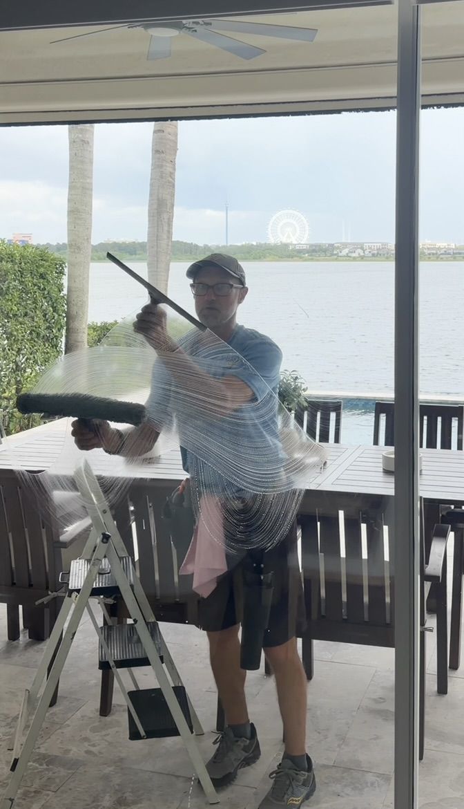 Sun Sands technician cleaning a window in Windermere, FL