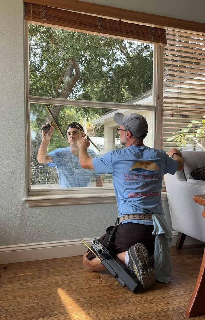 Sun Sands technician cleaning a window in Windermere, FL