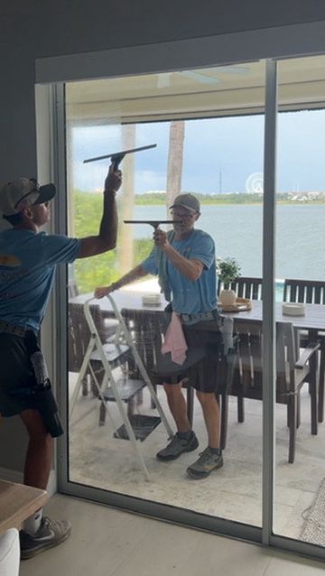 Sun Sands technician cleaning a window in Windermere, FL
