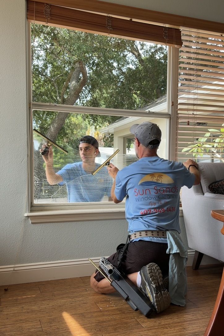 Sun Sands technician cleaning a window in Windermere, FL