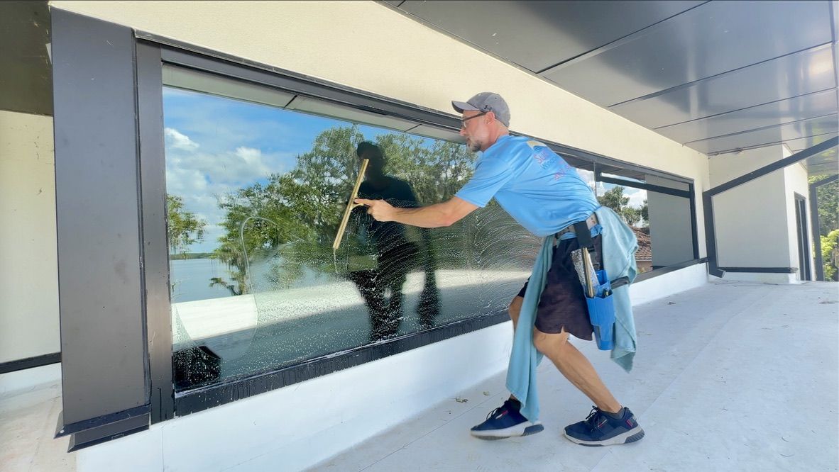 Sun Sands technician cleaning a window in Windermere, FL