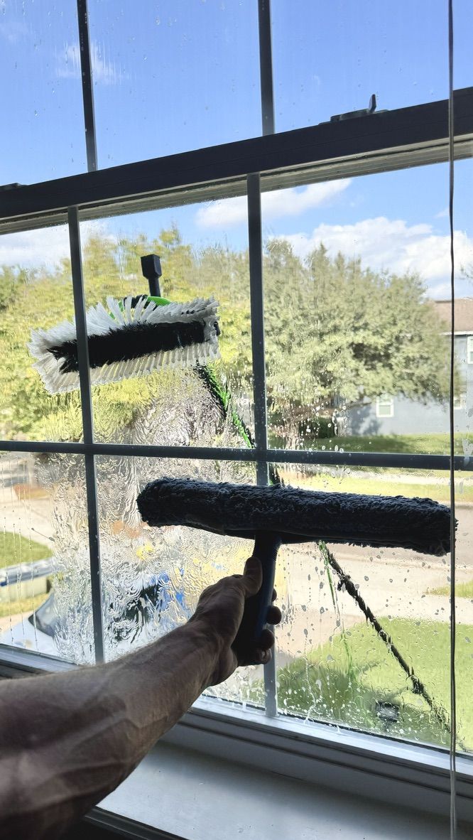 Sun Sands technician cleaning a window in Windermere, FL