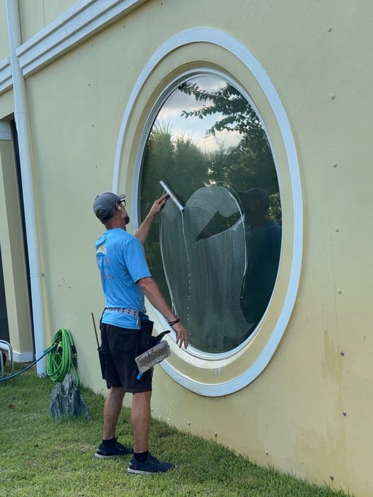 Sun Sands technician cleaning a window in Windermere, FL