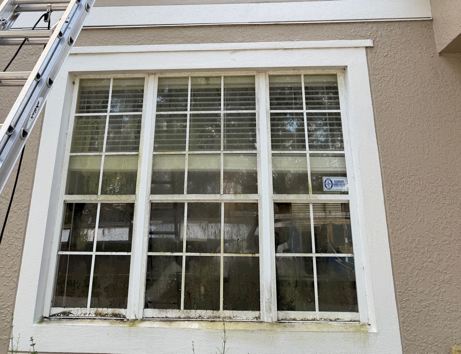 Sun Sands technician cleaning a window in Windermere, FL
