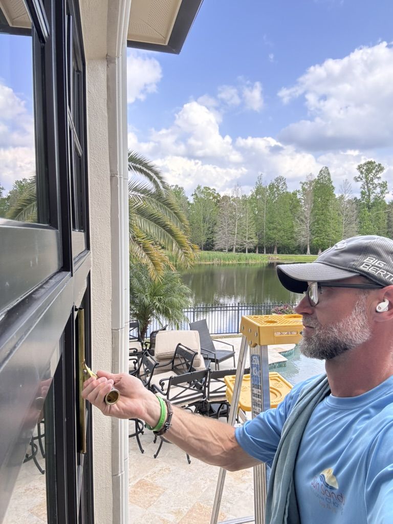 Sun Sands technician cleaning a window in Windermere, FL