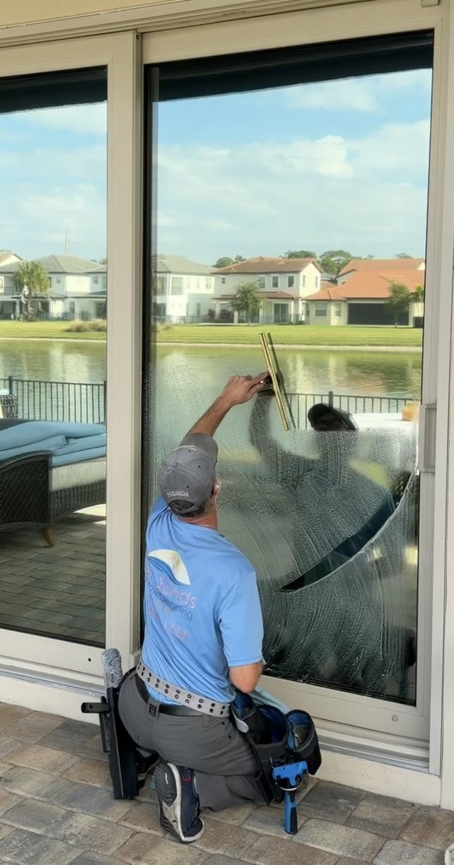 Sun Sands technician cleaning a window in Windermere, FL